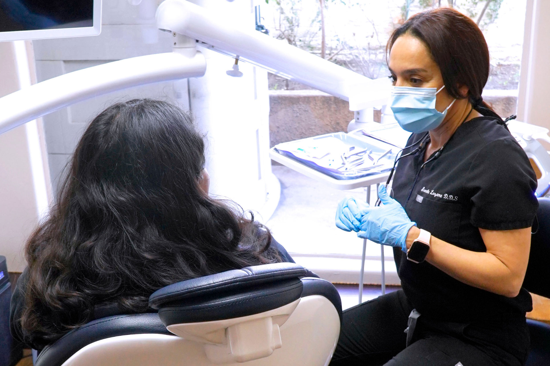 Dr. Lezama talking with patient in exam room