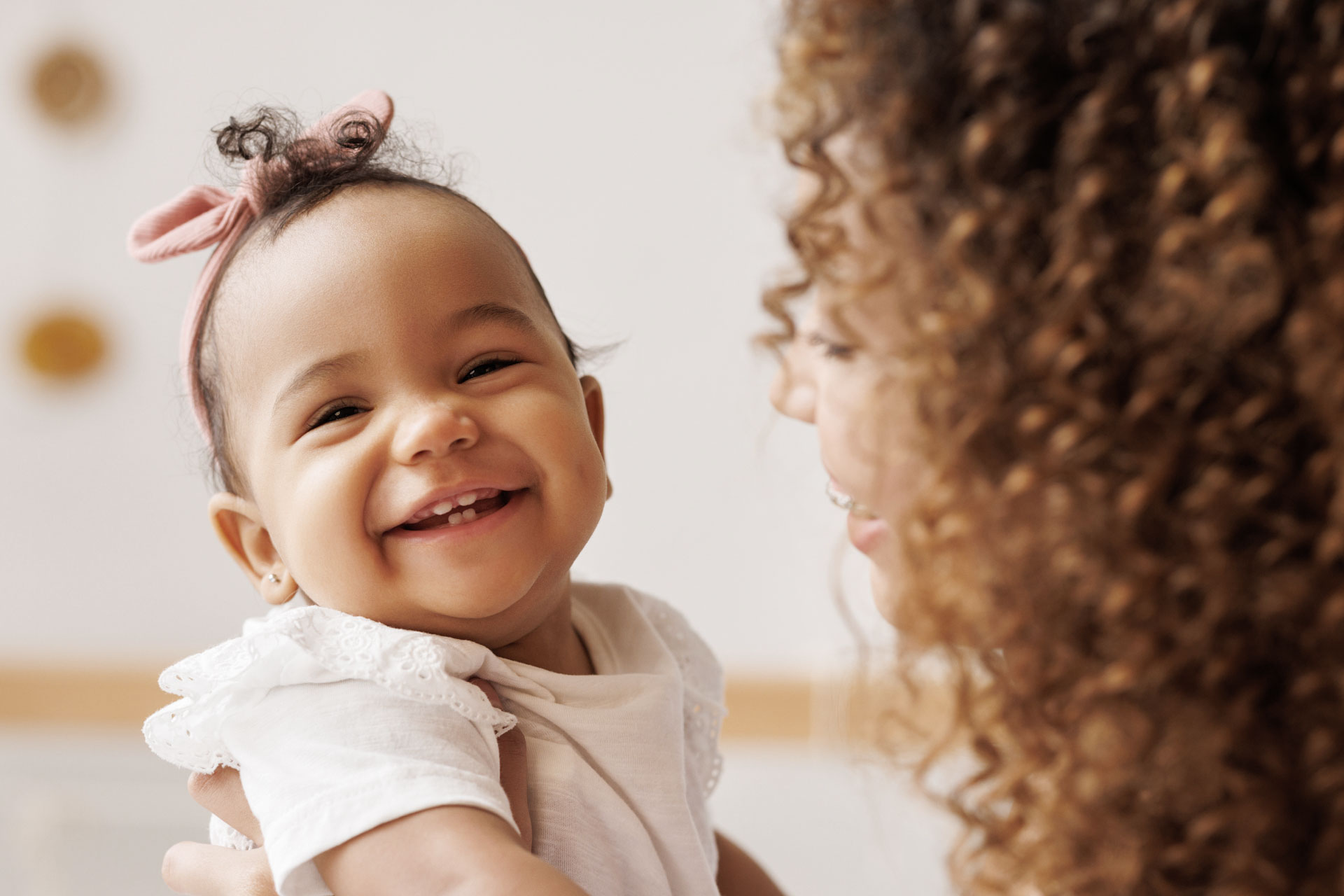 young mother holding 18 month old daughter