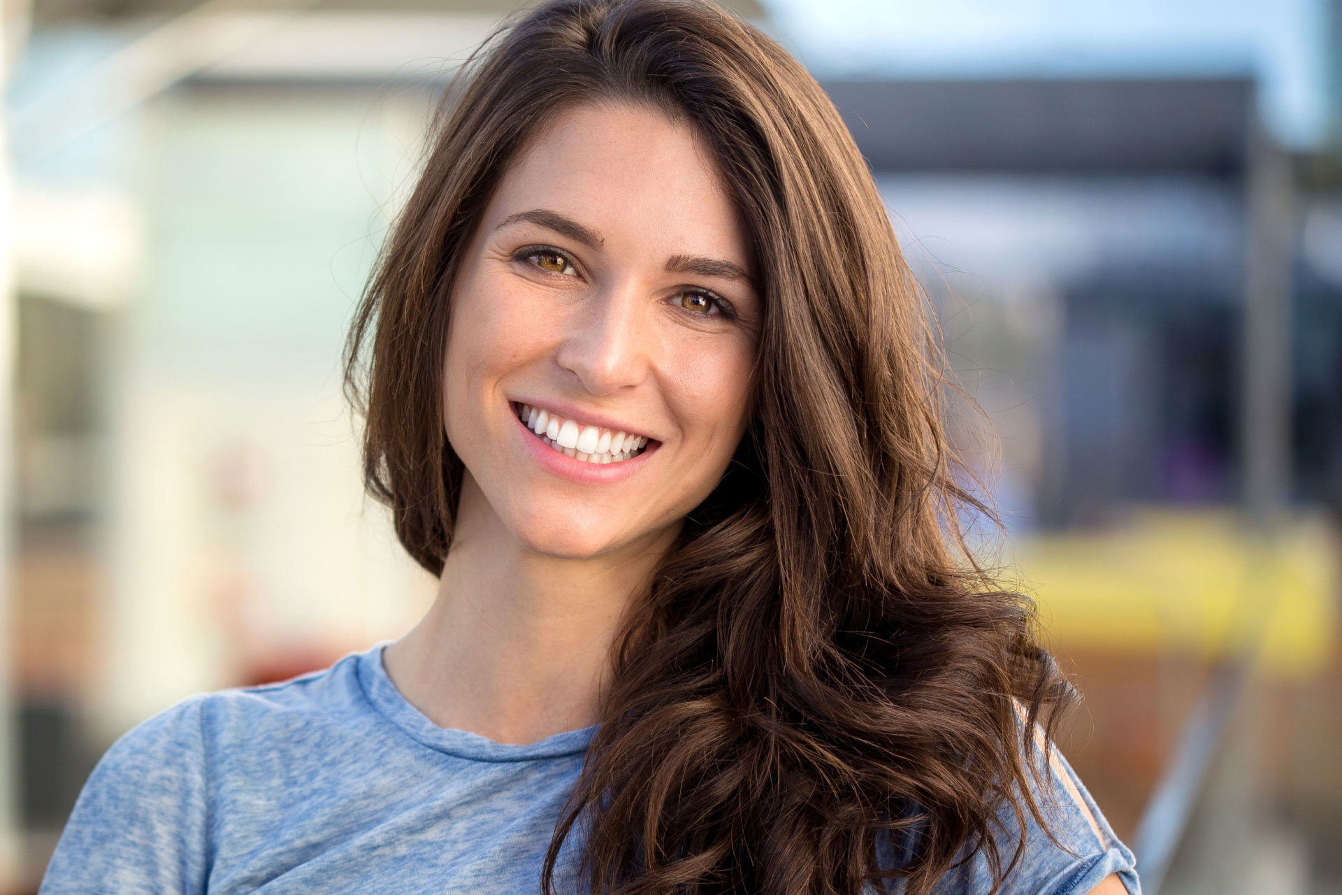 woman with long brown hair smiling at the camera